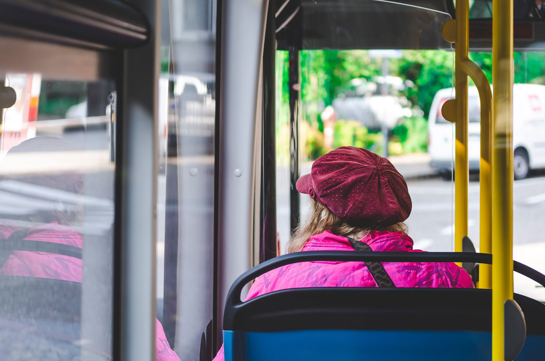 Woman riding on a bus.